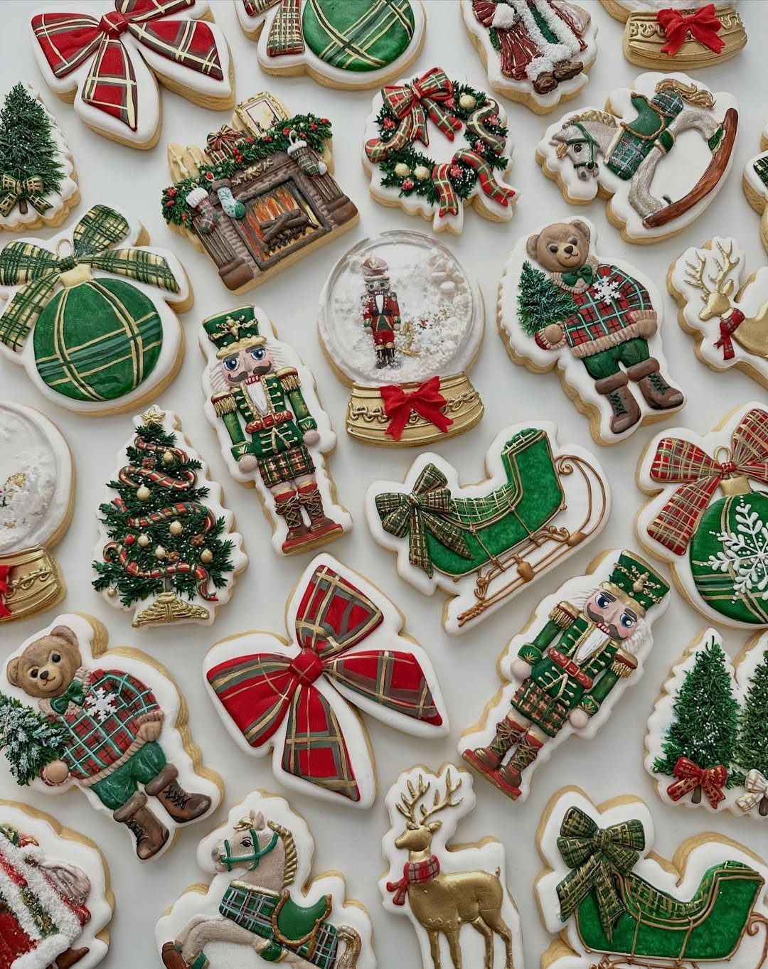 Decorated Christmas sugar cookies featuring nutcrackers, reindeer, trees, and festive bows on white background.